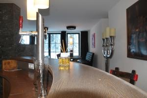 a dining room with a wooden table with glasses on it at Ferienhaus Fassl in Saalbach Hinterglemm