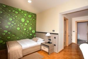 מיטה או מיטות בחדר ב-Hotel Calypso