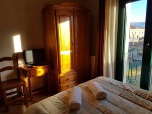 Postel nebo postele na pokoji v ubytování Hostal Maury