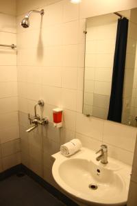 a bathroom with a sink and a mirror at Ginger Guwahati in Guwahati