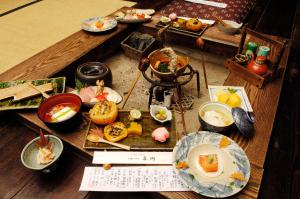 a table topped with plates of food on a table at Yamazatonoiori Soene in Takayama