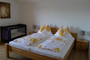 a bedroom with a bed with two pillows on it at Ferienwohnung Zirmheim in Westendorf
