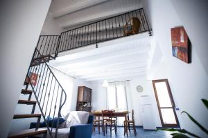 a living room with a staircase and a table at Appartamento La Marina in Castellammare del Golfo