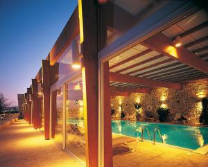 a building with a swimming pool next to a building at Ramon Inn by Isrotel Collection in Mitzpe Ramon
