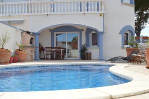 a swimming pool in front of a house at Raquel Koky in Empuriabrava