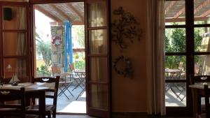 a door leading to a patio with a table and chairs at Ligaries in Kinion