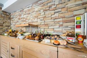 a buffet with many different types of bread and pastries at Un Hotel sur le Port in La Rochelle
