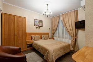 a hotel room with a bed and a chair at Tiara Domodedovo Guest House in Domodedovo