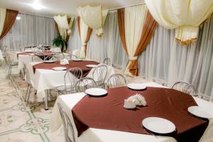 a banquet hall with tables and chairs and curtains at 4 Seasons in Boryspil