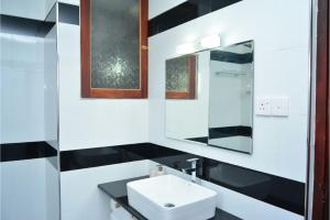 a bathroom with a sink and a mirror at Tropical Garden in Negombo