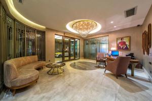 a lobby with a couch and a table and chairs at Hotel Morione & Spa Center in Istanbul