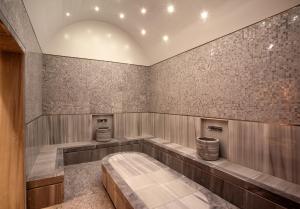 
a bath room with a tub and a toilet at Beresheet by Isrotel Exclusive in Mitzpe Ramon
