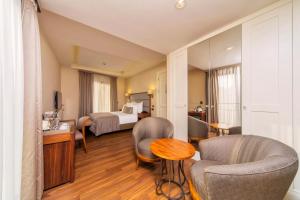 a hotel room with a bed and a table and chairs at Hotel Morione & Spa Center in Istanbul +134 photos