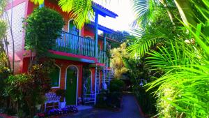 a colorful house with plants in front of it at Pousada Estrela do Mar in Florianópolis