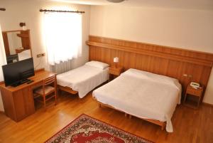 Postel nebo postele na pokoji v ubytování Albergo Stella Alpina
