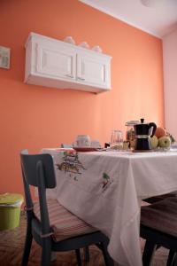a kitchen table with a white table cloth on it at Goga&Romeo in Pesaro