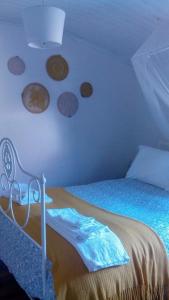 a bedroom with a bed with plates on the wall at Cantinho Redondo Gerês in Entre Ambos os Rios