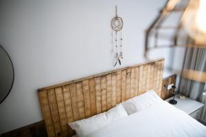 a bedroom with a bed and a clock on the wall at Bed & Breakfast De Plenkert in Valkenburg