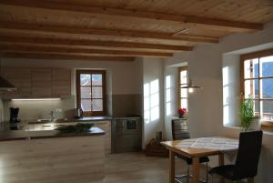 a kitchen with wooden ceilings and a table and chairs at Ferienwohnung Unterkofler in San Genesio Atesino +52 photos