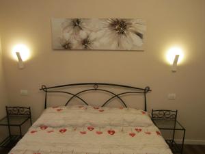 a bedroom with a bed with flowers on it at Glam Resort Giulia in La Spezia +37 photos