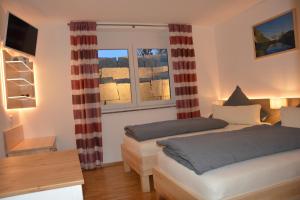 a bedroom with two beds and a window at Villa Müsli in Dettingen an der Iller