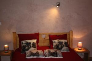 ein Schlafzimmer mit einem Bett mit roter Bettwäsche und zwei Lampen in der Unterkunft Gîte du Poirier in Le Tholy