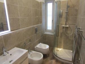 a bathroom with a shower and a toilet and a sink at Glam Resort Giulia in La Spezia