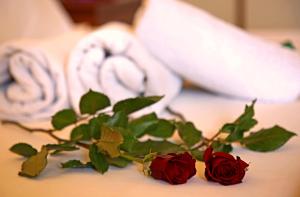 a bouquet of roses sitting on a table at Elysee Hotel in Sitia