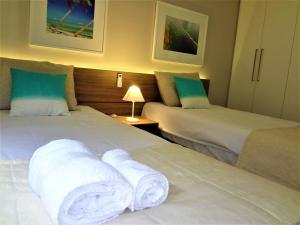 2 łóżka w pokoju hotelowym z ręcznikami w obiekcie Open Door Apartamentos - Maceió - Alagoas - BRA w mieście Maceió
