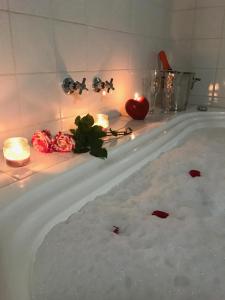 a bath tub with candles and flowers in it at Chalés Vila Flor in Gonçalves