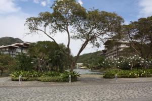 a park with white flowers and trees and buildings at Unit 507 Pico De Loro in Nasugbu
