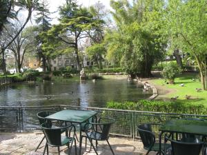a table and chairs next to a river with ducks at Appartement Lisbonne Estrela in Lisbon