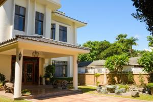 a house with a front door and a yard at Warm House B&B in Taitung City