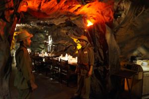 dos hombres parados frente a una mesa en una cueva en The President Hotel, en Bangalore