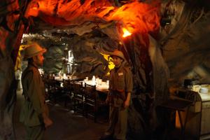 two men standing in front of a table in a cave at The President Hotel in Bangalore