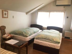 Letto o letti in una camera di Fujiyoshi
