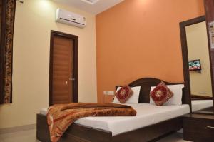 a bedroom with a bed in a room at Hotel M City in Amritsar