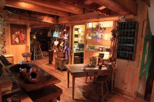 a room with a table and a room with wine bottles at Chalet Hotel Le Collet in Xonrupt-Longemer