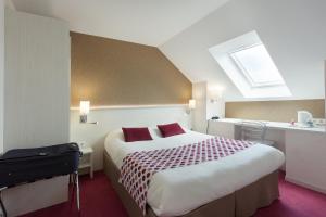 a hotel room with a large bed and a window at Logis Hôtel Alizéa Le Mans Nord in Saint-Saturnin +94 photos