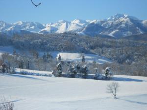 a snow covered field with mountains in the background at B&B La Ceramica Moline in Vicoforte