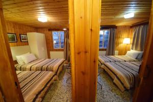 a room with two beds in a cabin at Christys Palace Hotel in Pedoulas