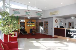 a store lobby with a cash register and a counter at Hampshire Holiday Parks - Queenstown Lakeview in Queenstown