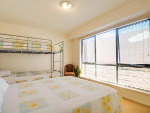 a bedroom with a bed and a large window at Fischer Torquay by Gold Star Stays in Torquay