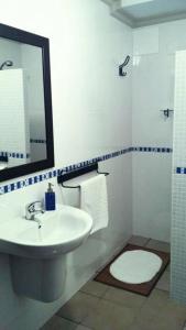 y baño con lavabo, espejo y aseo. en Alojamiento Mª Carmen, en El Real de la Jara