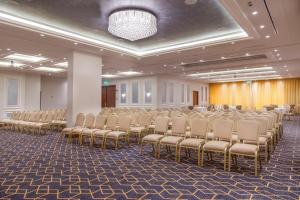 a room with a row of chairs in a hall at Gerasa Hotel in Amman