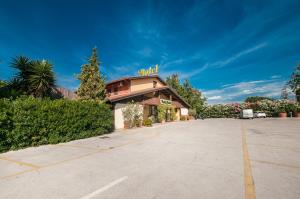 a building with a sign on the top of it at La Vecchia Fattoria in Loreto