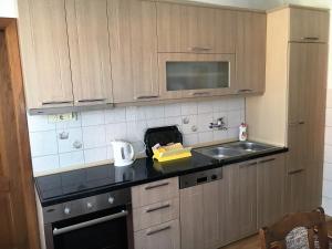 a kitchen with a sink and a counter top at Center Apartment in Pristina