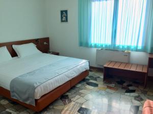 a bedroom with a bed and a table and a window at Albergo Isetta in Grancona