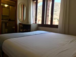 Ένα ή περισσότερα κρεβάτια σε δωμάτιο στο Albergo Isetta