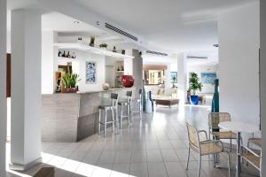 a kitchen and dining room with a bar and chairs at Terradimare Resort&Spa in San Teodoro